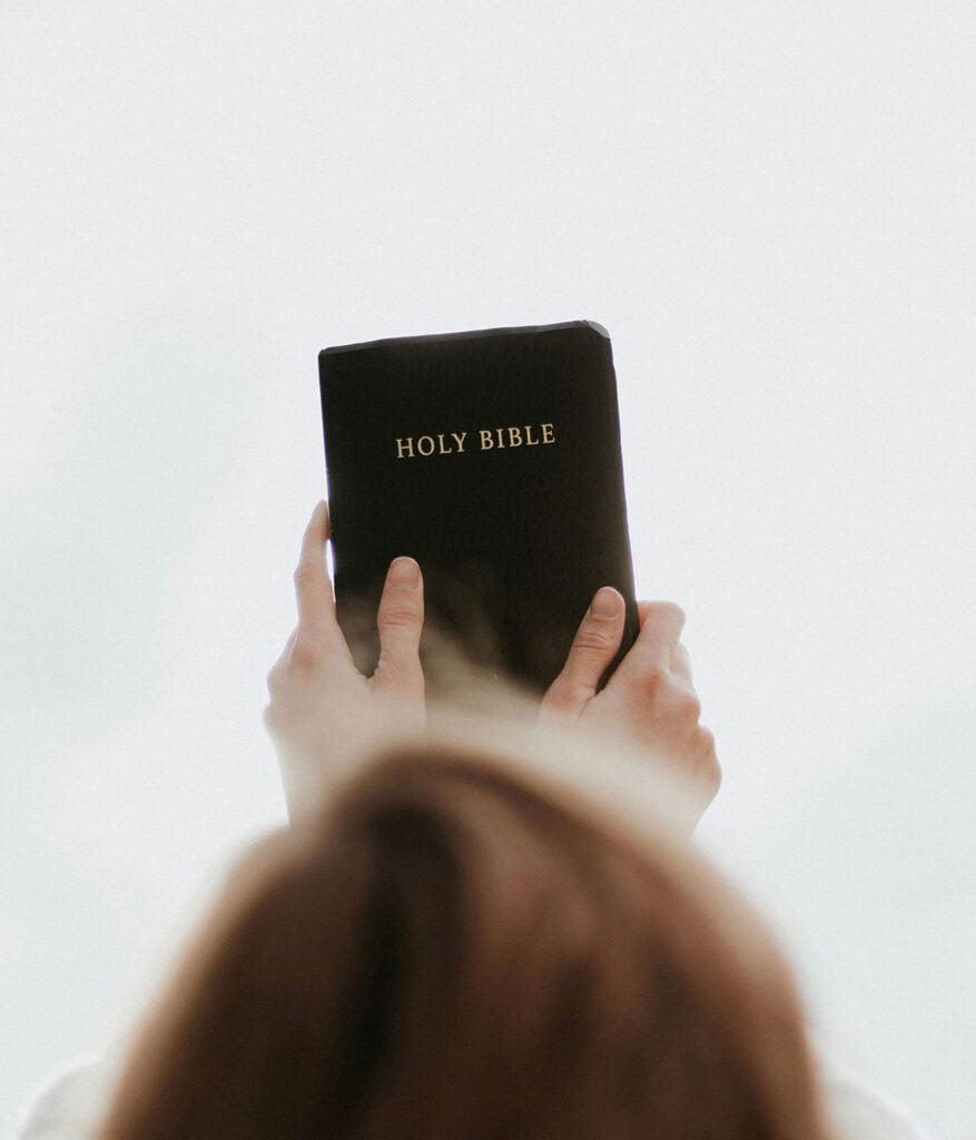 women holding Bible