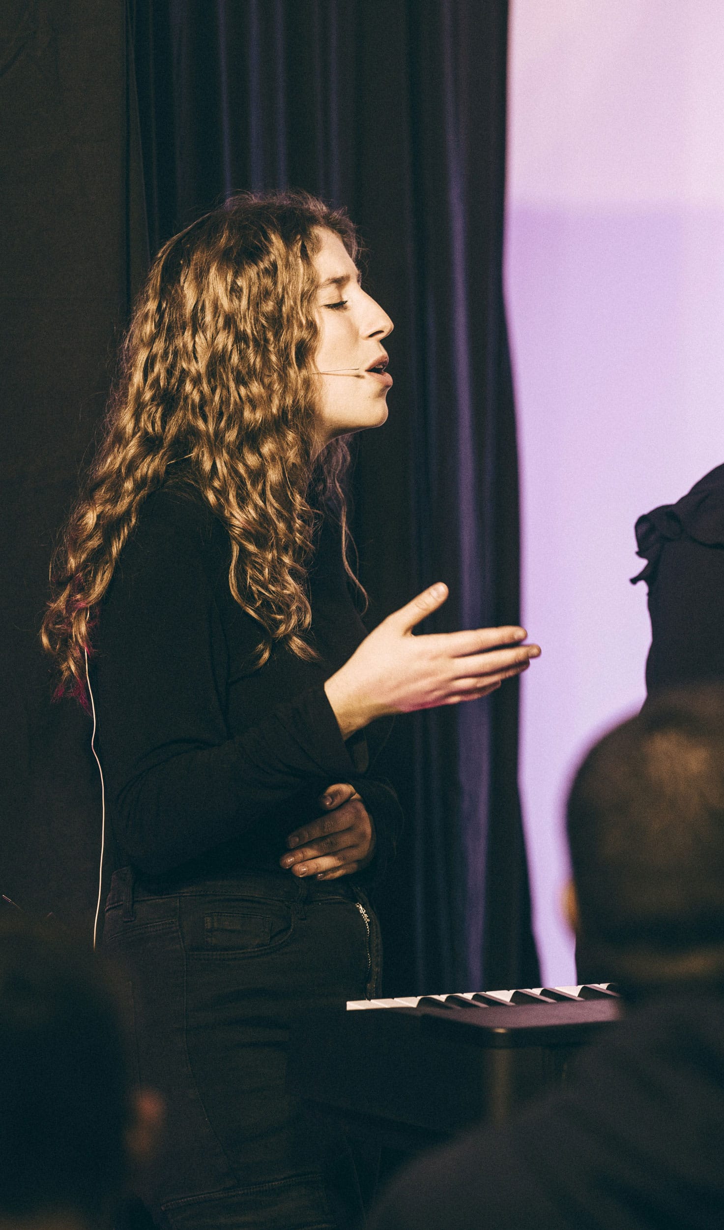 Woman speaking passionately at the House of Judah event.