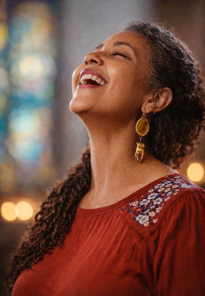 women praising God and smiling